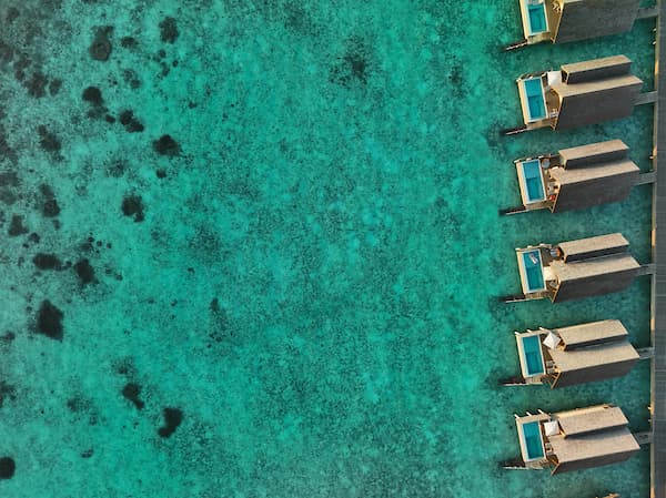Maldivler lagününde water villa ve turkuaz deniz manzarası